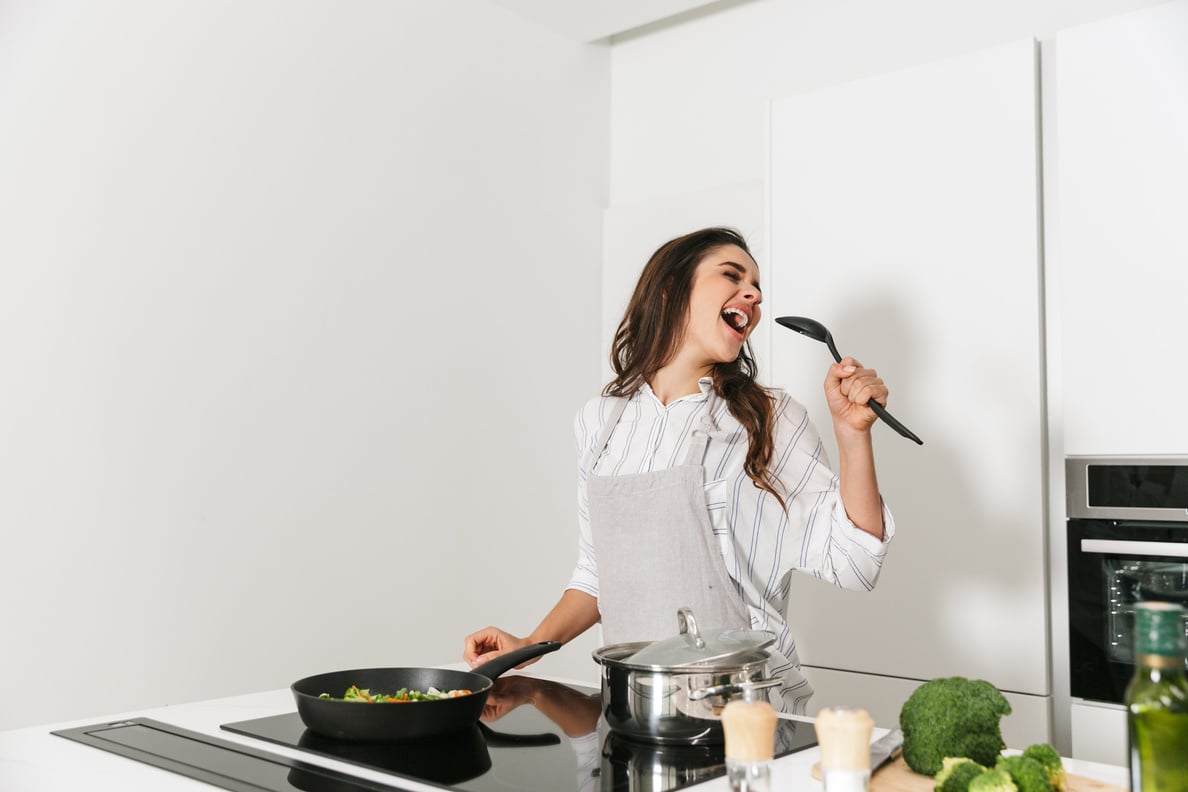 Woman Singing while Cooking at Home 