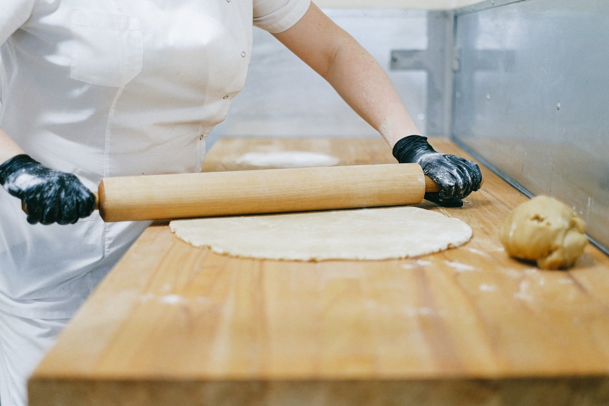 Pastry Chef Flattening a Dough